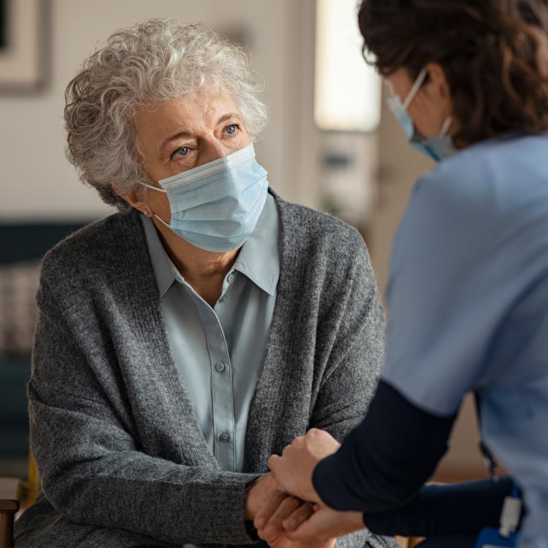 senior woman talking to caregiver