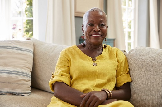 Woman sitting on the sofa and smiling at the camera