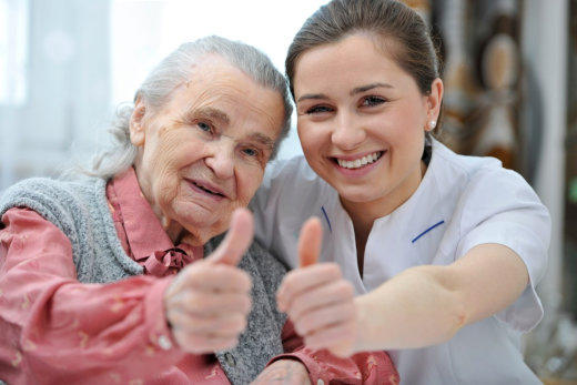 Young woman with senior woman showin