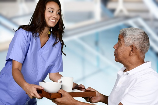 Nurse giving breakfast to the patient