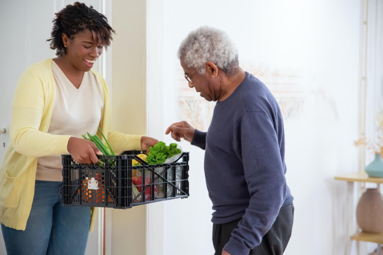 man is picking vegetables from the basket